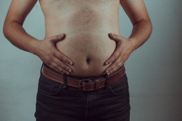 Naklejka premium overweight man closeup of belly front view