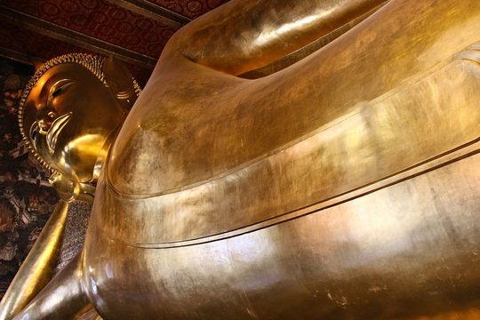 Reclining buddha statue in Wat Pho temple, Bangkok, Thailand. This is a popular tourist attraction in the city.  