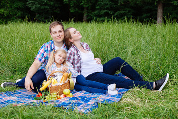 Happy family enjoying picnic in nature