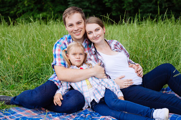 Happy family enjoying picnic in nature