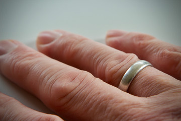 Caucasian mans right hand wearing platignum ring