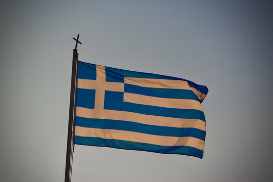 Greek flag flying in a blue sky