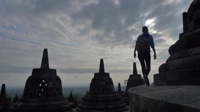 ourist backpacker exploring the Borobudur temple in Java island,Indonesia