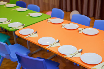 children's furniture and toys in kindergarten . kindergarten class with the Green chairs and small tables . School kindergarden nursery dining room .