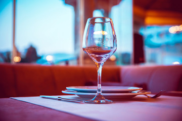 Selective focus. Empty glasses set in restaurant . Closeup image of empty glass ar blurred restaurant background. Close up picture of empty glasses in restaurant.