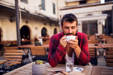 Man in shirt drinking coffee