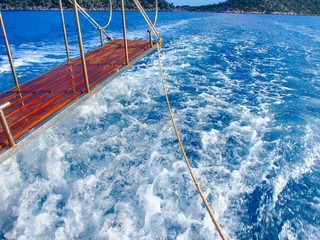 long wooden swim platform with a reeling .and ship waves beyond