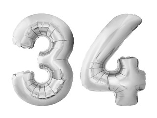 Number 34 thirty four made of silver inflatable balloons isolated on white background. Chrome silver helium balloons forming 34 thirty four. Birthday concept