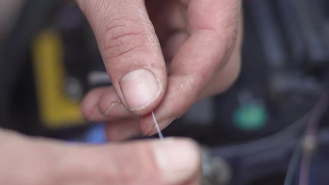 Close up shot of a technician hands splicing an optical fiber cable