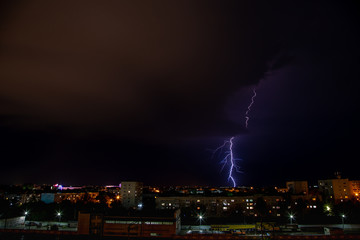 Purple lightning above city