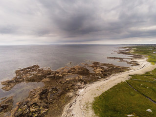 West coast of Ireland, county Galway, Arran islands in the background. Cloudy sky, Aerial view.