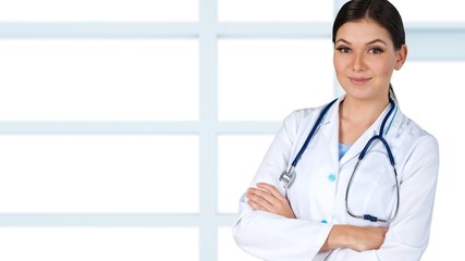 Attractive female doctor  on background