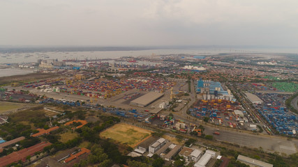 Fototapeta premium aerial view container terminal port surabaya. cargo industrial port with containers, crane. Tanjung Perak, indonesia. logistic import export and transport industry