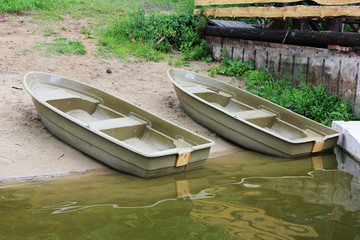 Two plastic boats on the banks of the river Istra