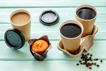 Coffee to go on mint green wooden background