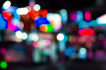 abstract unfocused colorful bokeh illumination of night city entertainment park 