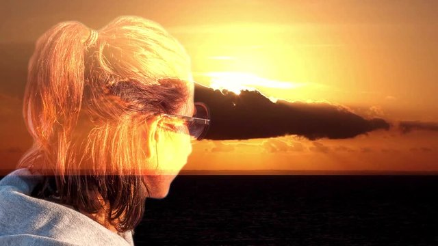 Cinemagraph sea sunset wallpaper with girl in transparency watching the sunset and awesome cloudy sky