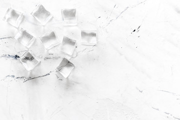 Pile of ice cubes on marble bar desk background top view mockup