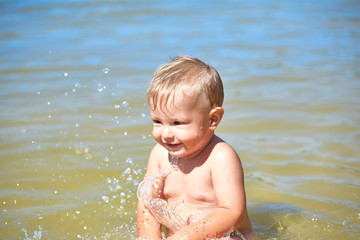 Baby bathes in water