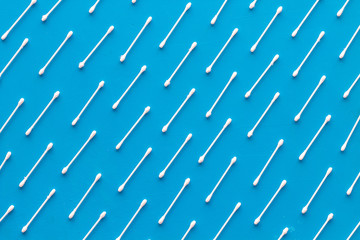 Hygiene cotton swabs for pattern on blue background top view
