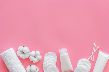 Hygiene cotton swabs, pads and cream for pattern on pink background top view mockup
