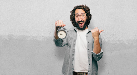 young fool man with an alarm clock