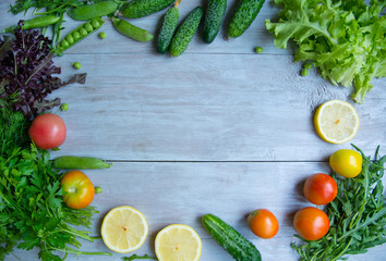 summer salad. cooking salad on a light wood background. different vegetables and greens