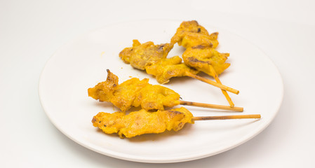 grilled pork satay with peanut sauce and vinegar on the white dish and white background isolate