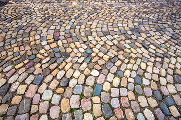 Colorful cobblestone pattern on old European cobbled street