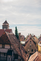 View from above of the roofs of the picturesque old houses of Rothenburg ob der Tauber, Bavaria, Germany, a sunny sunset.