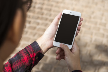 Woman using smart phone with blank screen