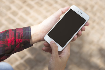 Women hands holding smart phone with blank screen sitting outside