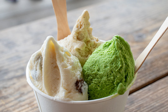 Gelatos in the cup on the wooden table outdoor
