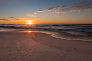 Fototapeta na wymiar Stunning, golden sunrise over Windang Beach, NSW, Australia