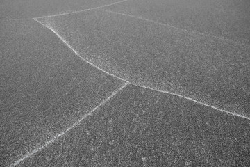 Patterns on sand, white lines left by waves on the beach.