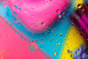 Micro molecular abstract pattern of colored oil bubbles on water. 