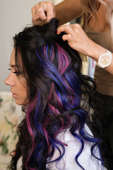 Naklejka premium Girl with colorful dyed hair. Model with perfect healthy dyed hair. Side view of attractive brunette woman with stylish hairdo and makeup