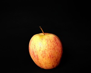 Organic apple from a Guatemalan farm on black background. fruits concept