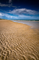 Beautiful Clean Beach with Ripples in the Sand on a Clear Day in Thailand.
