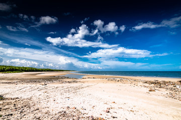Beautiful Beach with Clean Sand and a Clear Deep Blue Sky with Little Clouds in Thailand.