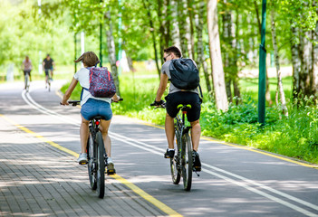 Cyclists ride on the bike path in the city Park 