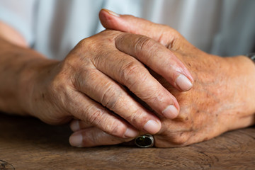 Senior man's holding his hands and praying, Close up & Macro shot, Selective focus, Asian Body skin part, Body language feeling, Religious concept