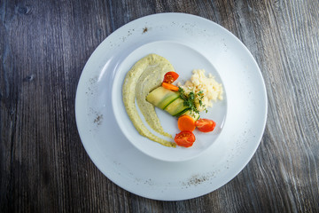 top view on rice and vegetables finely decorated with green sauce