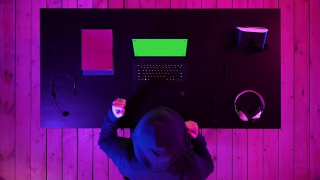 Lucky hacker won with his laptop. Green Screen Mock-up Display.