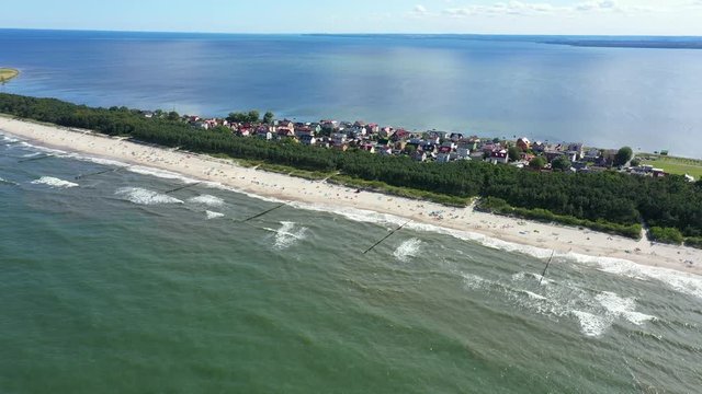 Beach in beautiful city Chalupy resort in Poland. Aerial video. Baltic Sea.Waves coming in.