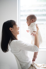 Young mother holding her baby