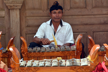 Indonesian man playing traditinal gamelan music in Bali Indonesia