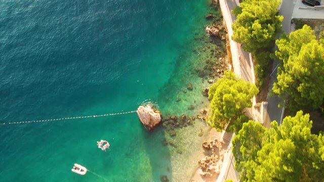 Bird eye view shot on the beautiful beach of Punta Rata beach during sunset in Brela, Croatia