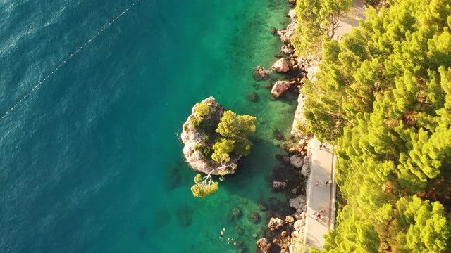 Aerial elevating shot on the famous rock of Punta Rata beach in Brela, Croatia