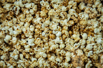 Yummy scattered sweet popcorn texture background.